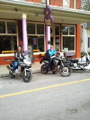 Girls riding motorcycles in front of the Purple Fiddle Thomas, WV