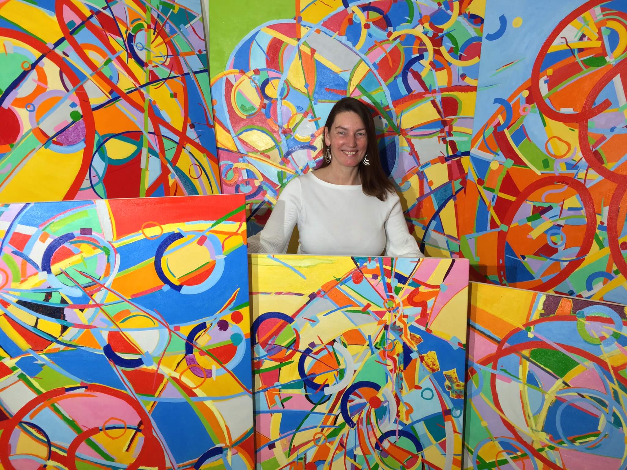 Dorit Brauer Standing with her paintings